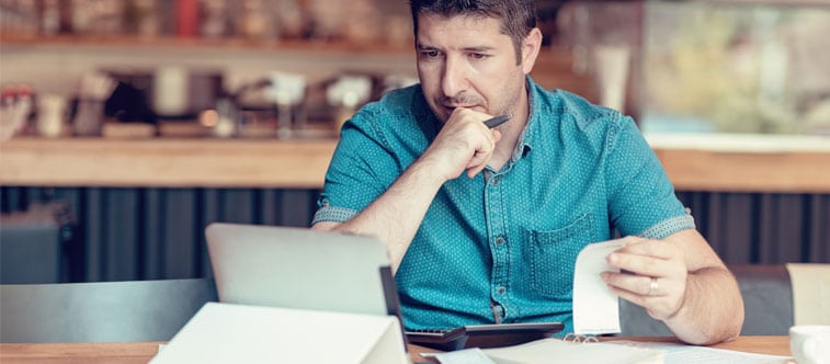 Man reading business reviews on a tablet